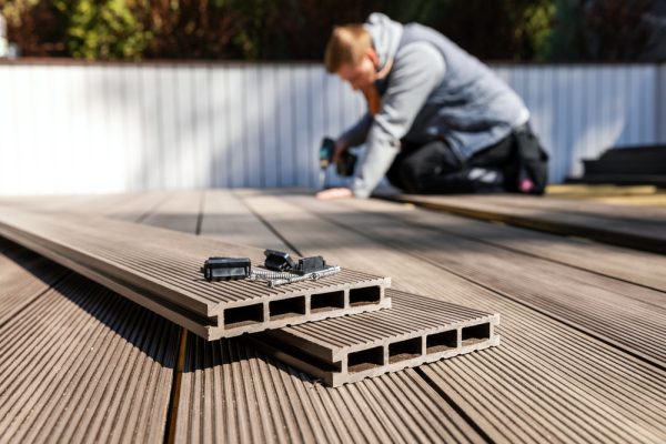 A modern composite deck being installed – a durable and stylish option for maximizing outdoor space with custom designs